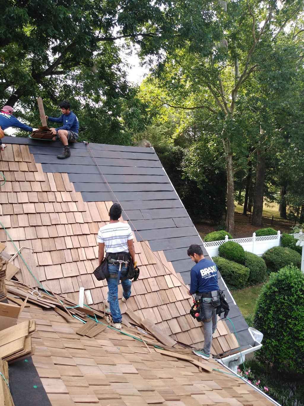 Crew working a steep cedar shake roof